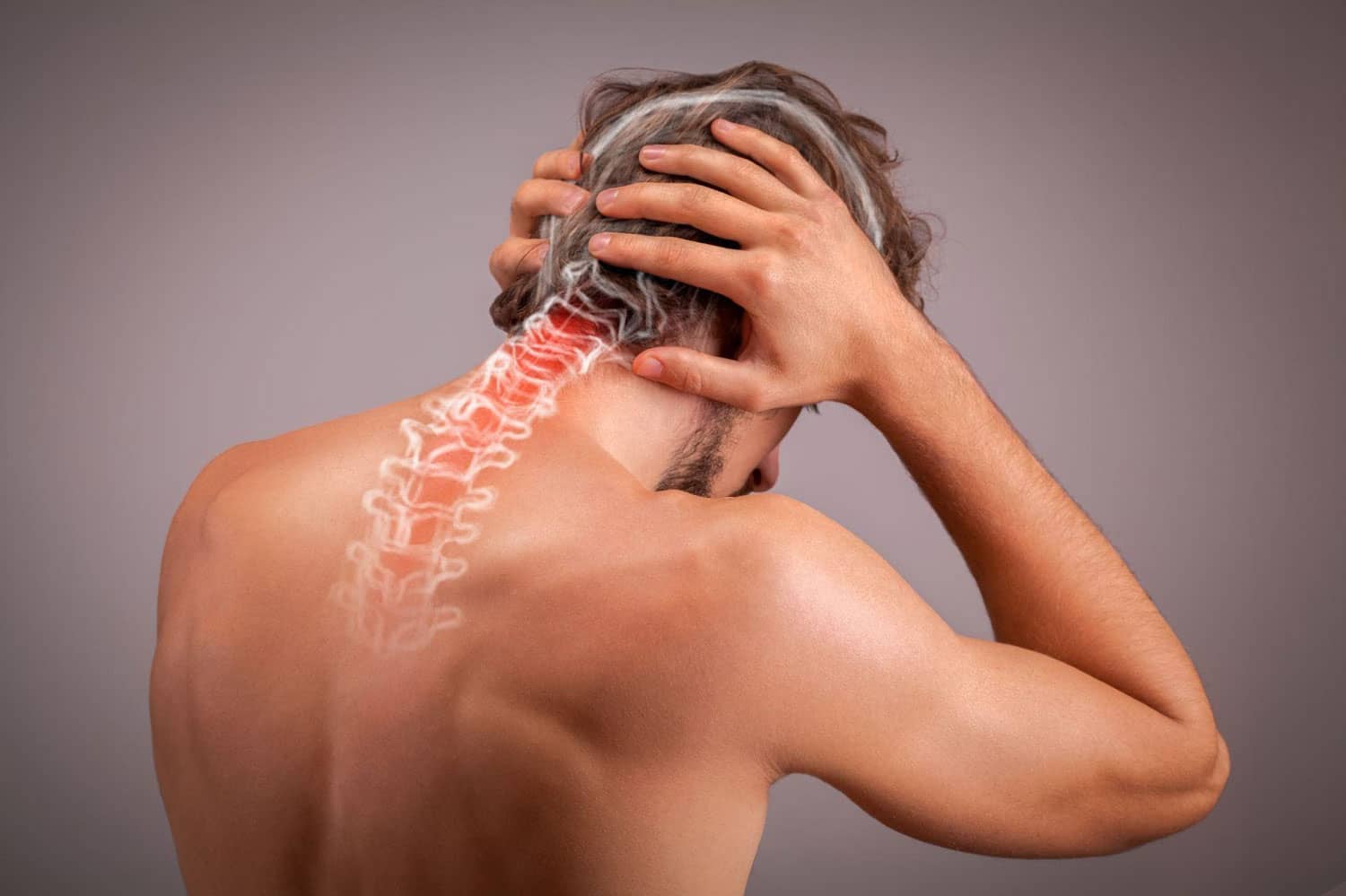 A man holds the back of his head because of neck pain.