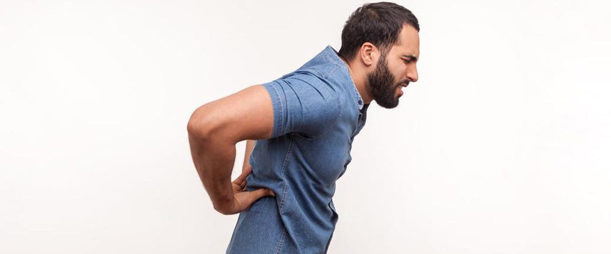 A man suffering from middle back pain.