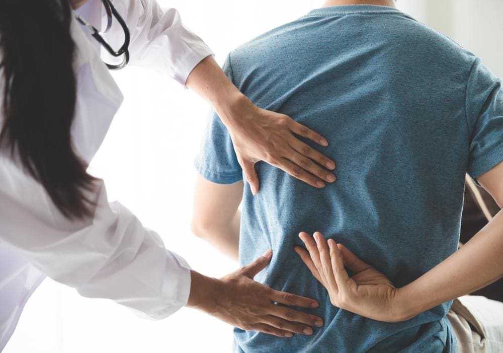 A chiropractor is treating a man for personal injuries. 