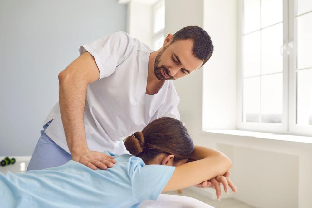 A woman is getting a chiropractic adjustment to ease the symptoms of a recent concussion. 