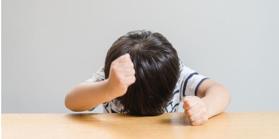 A little boy is throwing a fit as he struggles with ADHD.
