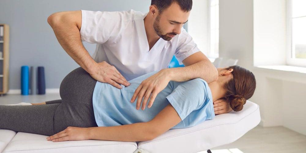 A chiropractor is treating a patient for pain.