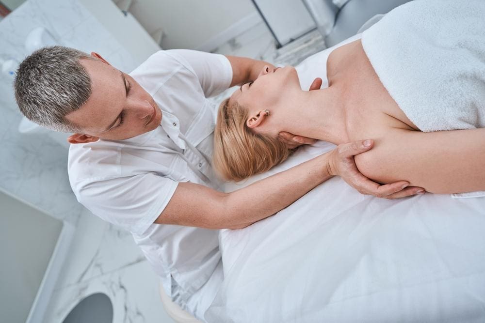 a woman is getting osteopathic treatment. 