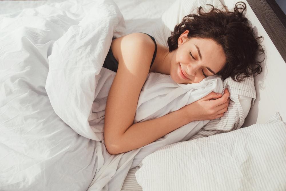 A woman is enjoying a blissful nights sleep.