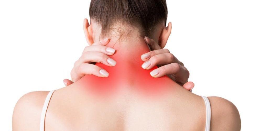 Woman holding the back of her neck in pain.